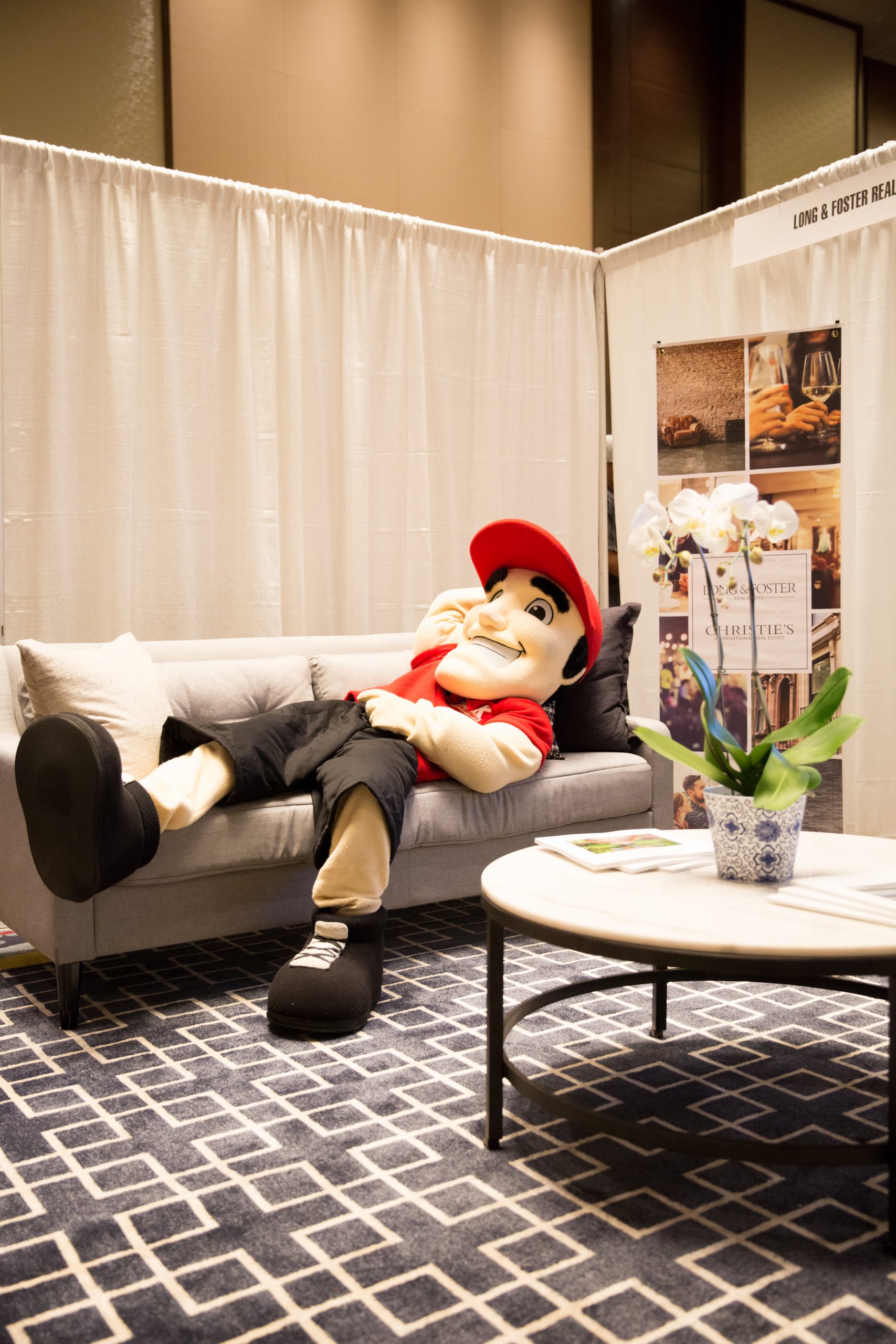 company mascot lying on a couch