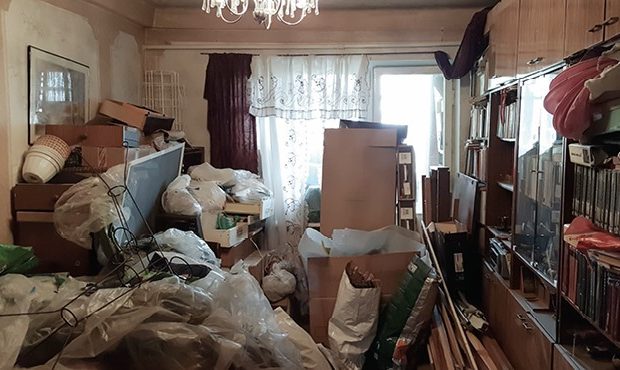 Cluttered room filled with bags, boxes, and stacked items