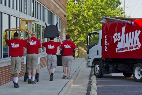 commercial junk removal crews disposing office furniture