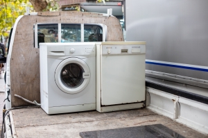 Discarted Dishwasher and Washing Machine on A Junk Removal Truck