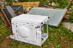 Old Damaged Appliances in House Backyard