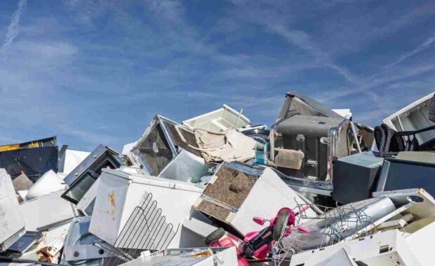 Pile of Discarded Appliances at Junkyard