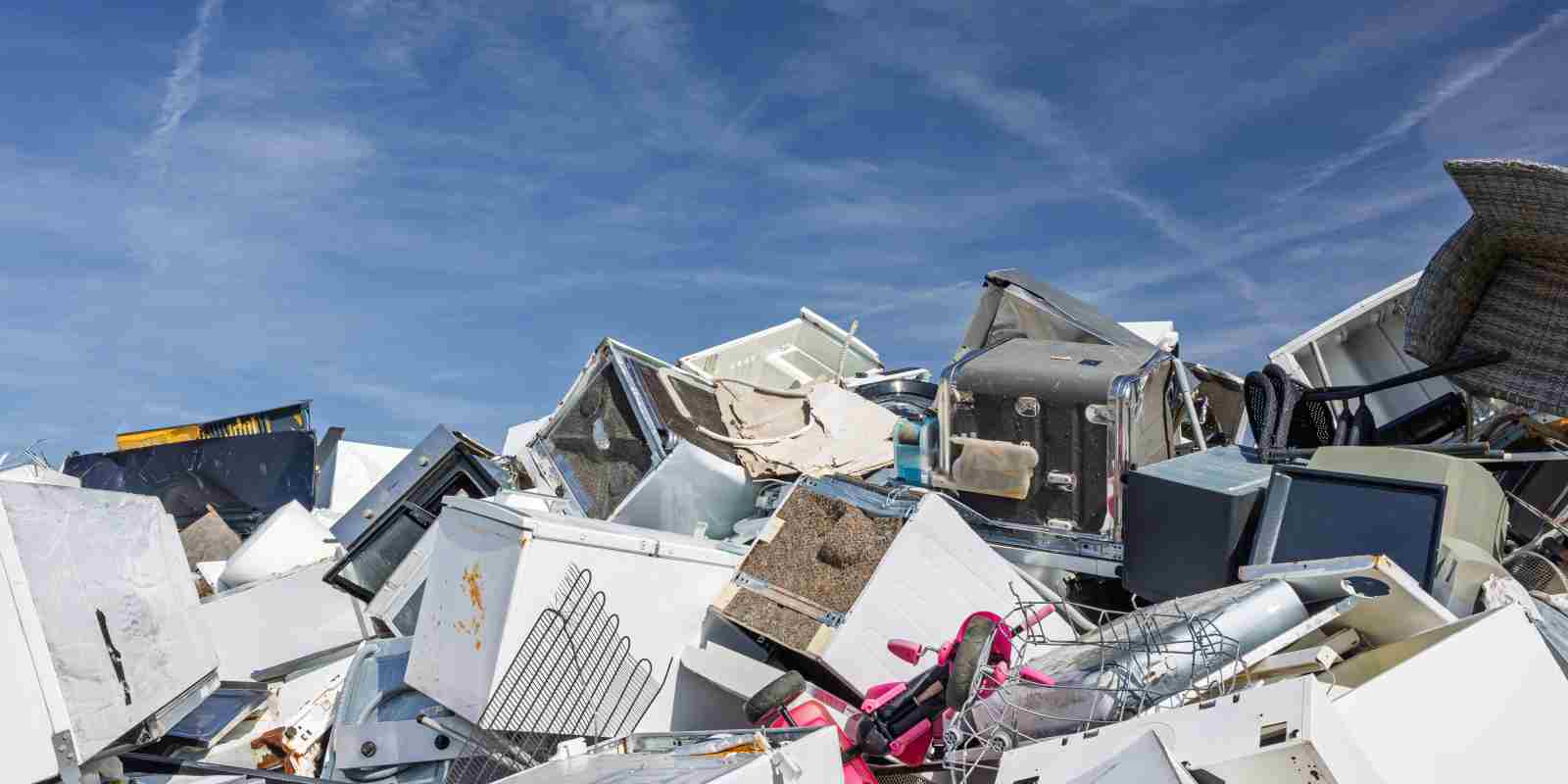 Pile of Discarded Appliances at Junkyard