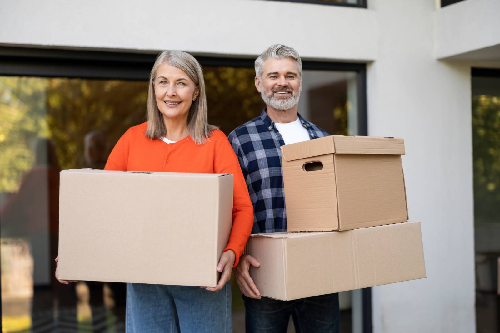 Couple Holding Boxes After Downsizing Their Home In 2026