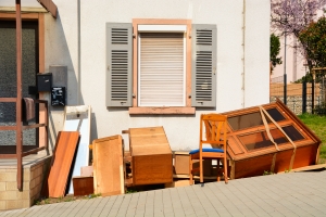Pile of Old Furniture for Donation in Front of a House