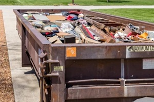 dumpster truck filled with junk material