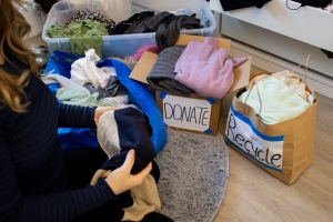 Woman Sorting Clothes for Recycling and Donation