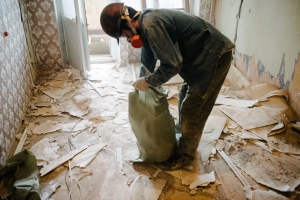 Junk Removal Worker Cleaning Trash in Apartment