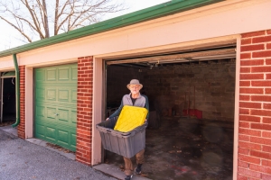 Senior Man Preparing His Garage for Cleanout by Moving Useful Items Out