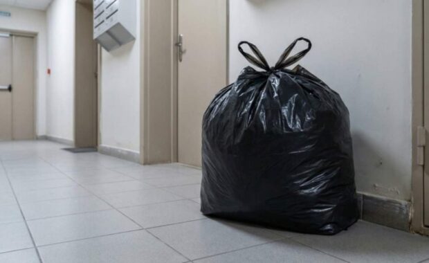 Trash Bag Put by Junk Removal Service in Hallway of Apartment Building