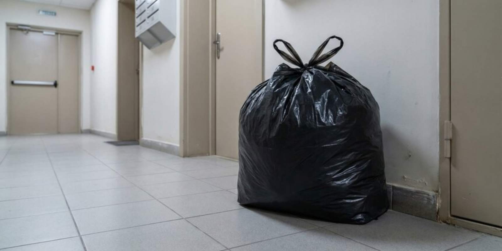 Trash Bag Put by Junk Removal Service in Hallway of Apartment Building