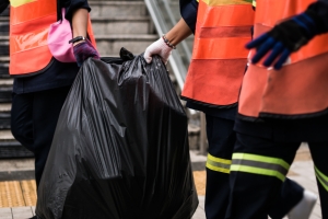 Junk Removal Workers Picking Grabage Bags for Loading