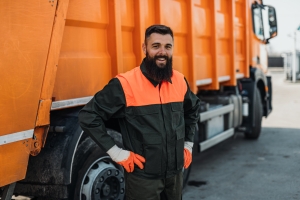 Smiling Junk Removal Worker Standing Near Garbage Collection Truck