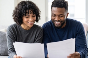 Couple Comparing Junk Removal Service Quotes at Home