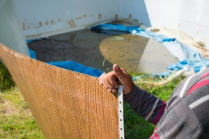 Junk Removal Worker Dismantling Above-Ground Old Pool
